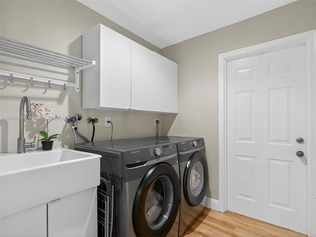 782 Lake Blvd, Weston, FL 33326 - laundry room with independent washer and dryer, light wood-style flooring, and cabinet space