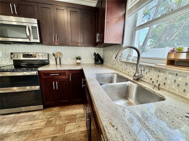 535 SW 181st Way, Pembroke Pines, FL 33029 - kitchen featuring stainless steel appliances, backsplash, light stone countertops, and dark brown cabinetry