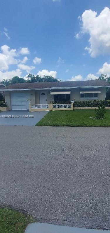 4926 NW 48th Ave, Tamarac, FL 33319 - view of front of home featuring concrete driveway