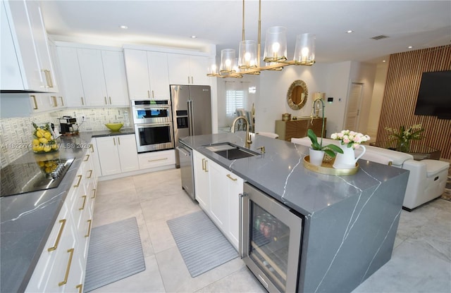 21420 SW 127th Pl, Miami, FL 33177 - kitchen featuring stainless steel appliances, a kitchen island with sink, backsplash, white cabinetry, and recessed lighting