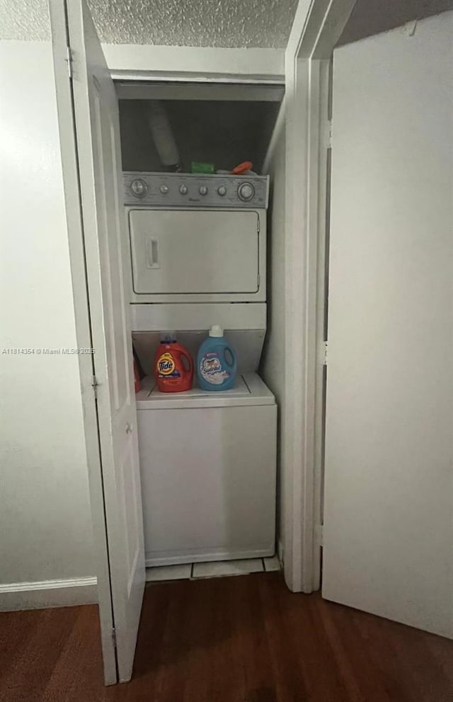 14901 SW 82nd Ter Unit 1-207, Miami, FL 33193 - laundry area with stacked washer / drying machine, wood finished floors, and a textured ceiling