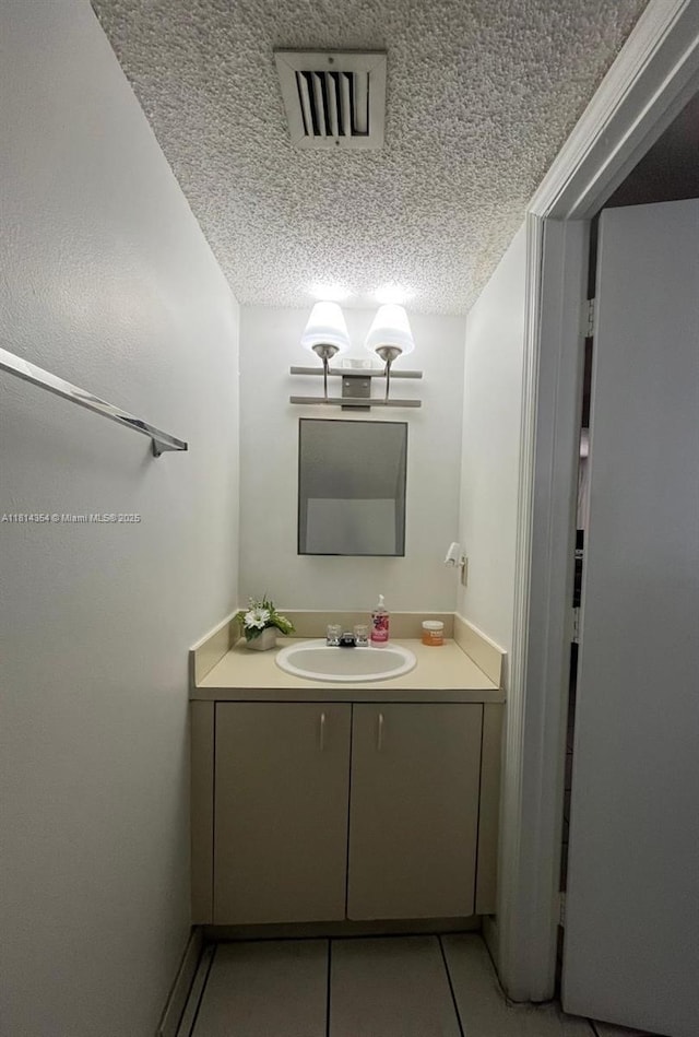 14901 SW 82nd Ter Unit 1-207, Miami, FL 33193 - bathroom featuring vanity, a textured ceiling, and tile patterned floors