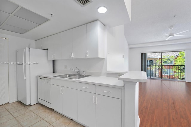 4183 N Haverhill Rd Unit 710, West Palm Beach, FL 33417 - kitchen with white appliances, open floor plan, light countertops, a peninsula, and white cabinets