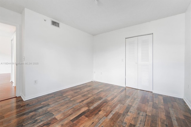 4183 N Haverhill Rd Unit 710, West Palm Beach, FL 33417 - unfurnished bedroom featuring hardwood / wood-style floors and a closet