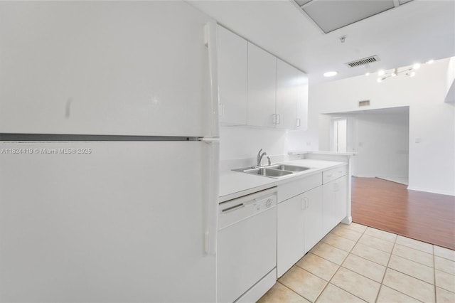 4183 N Haverhill Rd Unit 710, West Palm Beach, FL 33417 - kitchen featuring white appliances, light tile patterned floors, white cabinetry, and light countertops