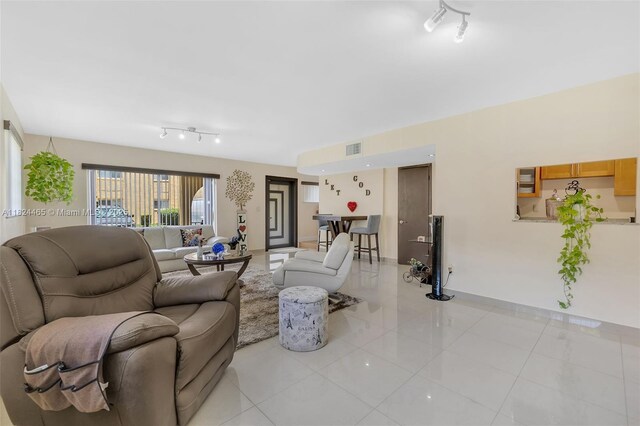 13705 SW 84th St Unit H, Miami, FL 33183 - living room featuring light tile patterned floors and rail lighting