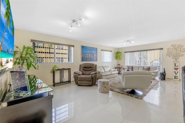 13705 SW 84th St Unit H, Miami, FL 33183 - tiled living room with rail lighting and baseboards
