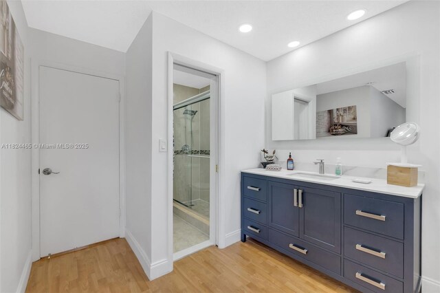 13705 SW 84th St Unit H, Miami, FL 33183 - bathroom with a shower stall, wood finished floors, vanity, and recessed lighting