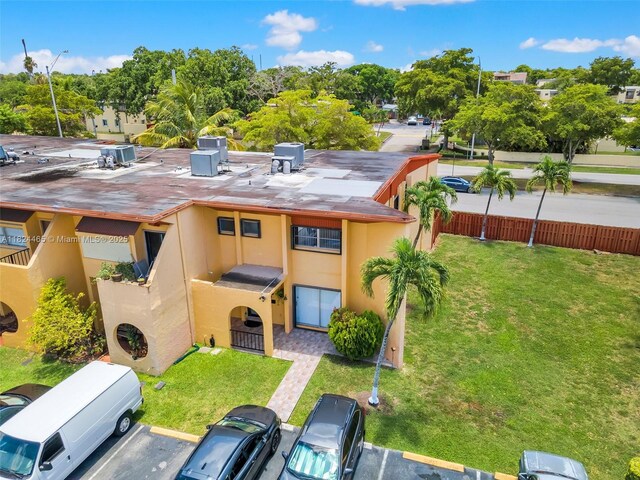 13705 SW 84th St Unit H, Miami, FL 33183 - rear view of property with uncovered parking, stucco siding, and view of wooded area