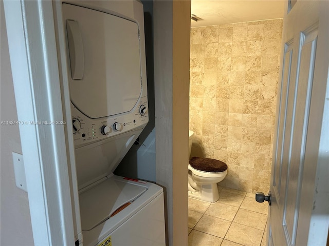 5818 Swordfish Ct Unit D, Tamarac, FL 33319 - laundry room with stacked washing machine and dryer, tile walls, and light tile patterned floors