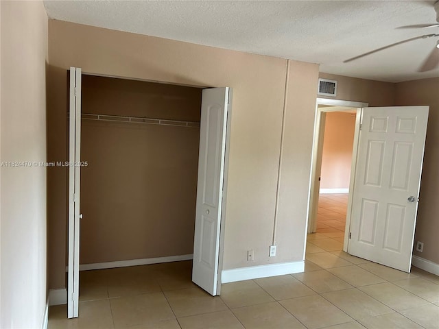 5818 Swordfish Ct Unit D, Tamarac, FL 33319 - unfurnished bedroom with light tile patterned flooring, a closet, and a textured ceiling