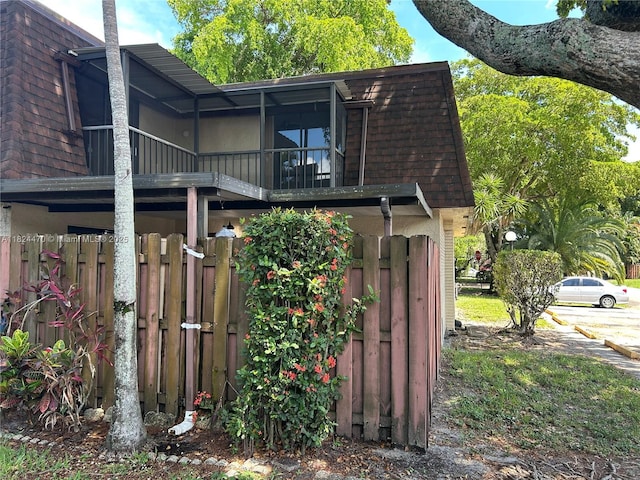 5818 Swordfish Ct Unit D, Tamarac, FL 33319 - view of side of property featuring mansard roof and a shingled roof