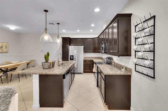 8144 Cascada Isles Dr, Cooper City, FL 33024 - kitchen with appliances with stainless steel finishes, dark brown cabinetry, light stone countertops, light tile patterned floors, and recessed lighting
