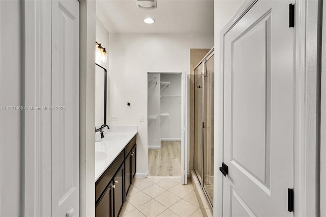 8144 Cascada Isles Dr, Cooper City, FL 33024 - full bath featuring double vanity, a stall shower, a spacious closet, and tile patterned floors