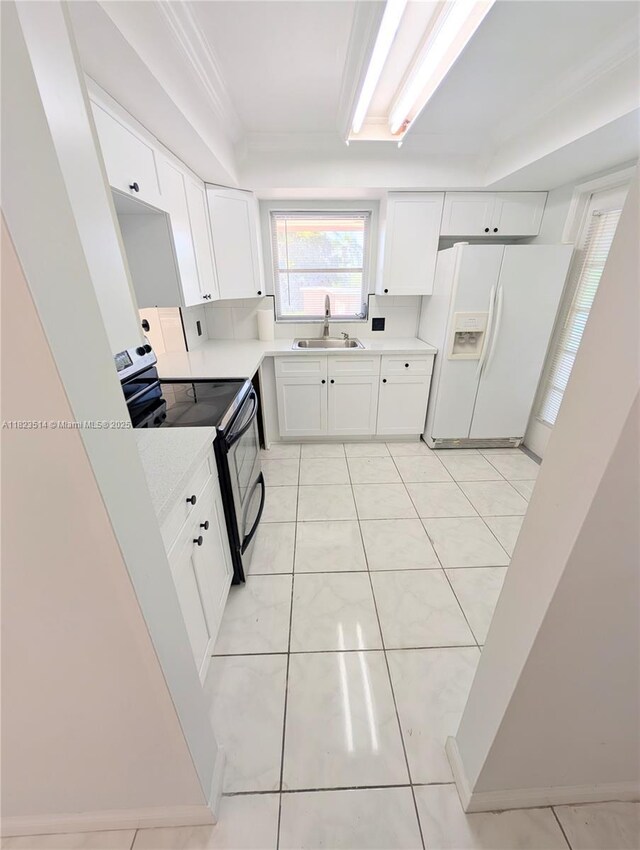 14901 SW 4th St Unit 9A, Pembroke Pines, FL 33027 - kitchen with white refrigerator with ice dispenser, electric stove, white cabinetry, light countertops, and crown molding