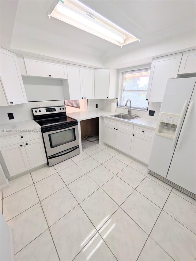 14901 SW 4th St Unit 9A, Pembroke Pines, FL 33027 - kitchen featuring electric range, white fridge with ice dispenser, light countertops, and white cabinetry