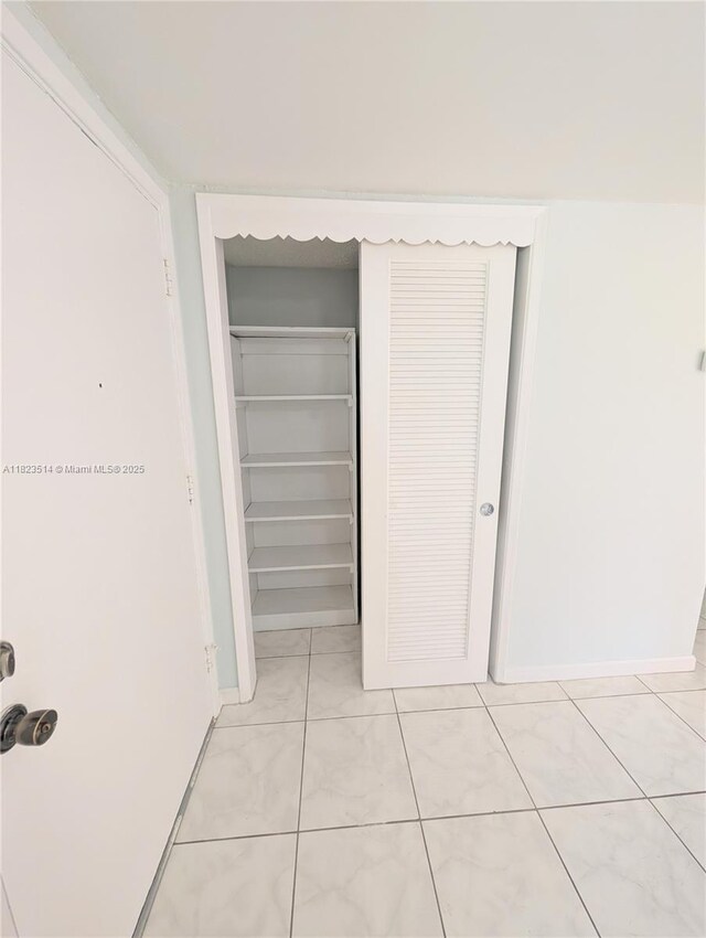 14901 SW 4th St Unit 9A, Pembroke Pines, FL 33027 - corridor featuring light tile patterned flooring and baseboards