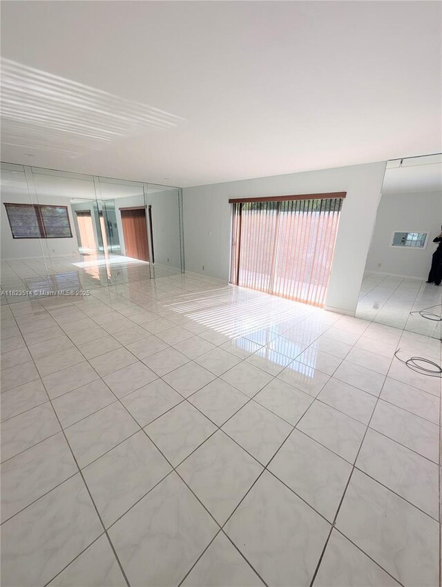 14901 SW 4th St Unit 9A, Pembroke Pines, FL 33027 - spare room with light tile patterned flooring