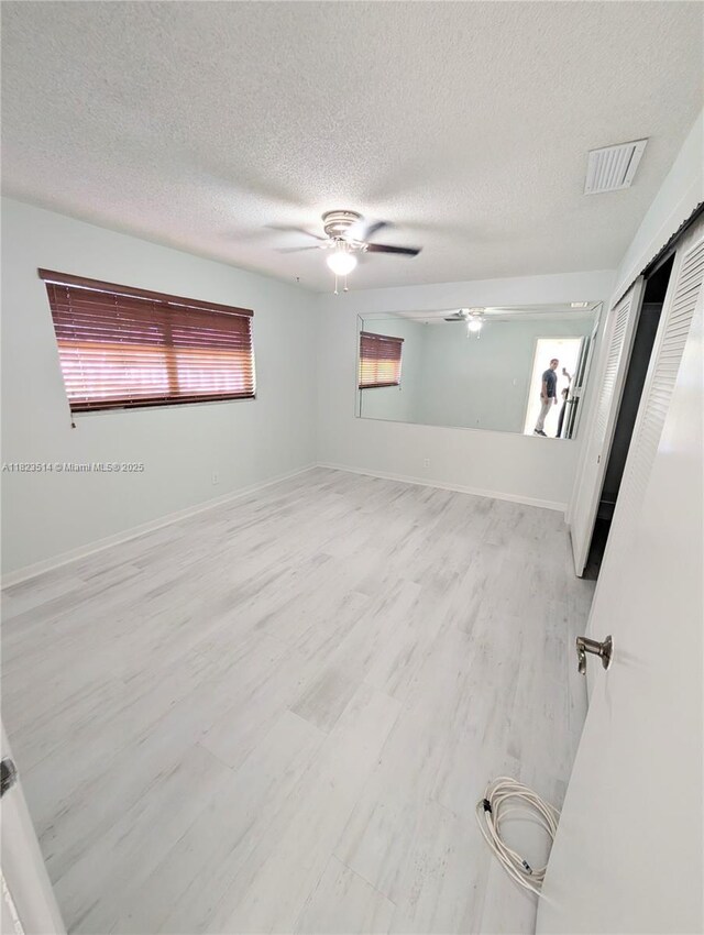 14901 SW 4th St Unit 9A, Pembroke Pines, FL 33027 - unfurnished room with ceiling fan, a textured ceiling, and wood finished floors