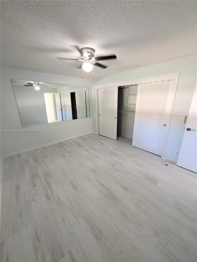 14901 SW 4th St Unit 9A, Pembroke Pines, FL 33027 - unfurnished bedroom with a textured ceiling, light wood-type flooring, ceiling fan, and a closet