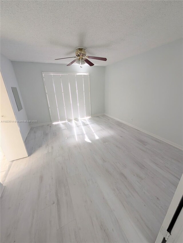 14901 SW 4th St Unit 9A, Pembroke Pines, FL 33027 - empty room featuring ceiling fan, a textured ceiling, and light wood-type flooring