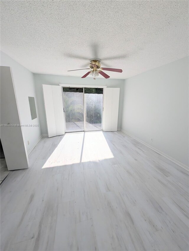 14901 SW 4th St Unit 9A, Pembroke Pines, FL 33027 - spare room with ceiling fan, a textured ceiling, and light wood finished floors
