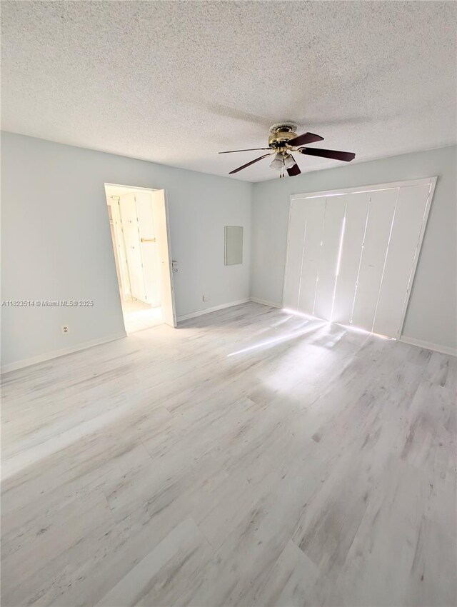 14901 SW 4th St Unit 9A, Pembroke Pines, FL 33027 - unfurnished bedroom featuring light wood finished floors, a textured ceiling, ceiling fan, and a closet