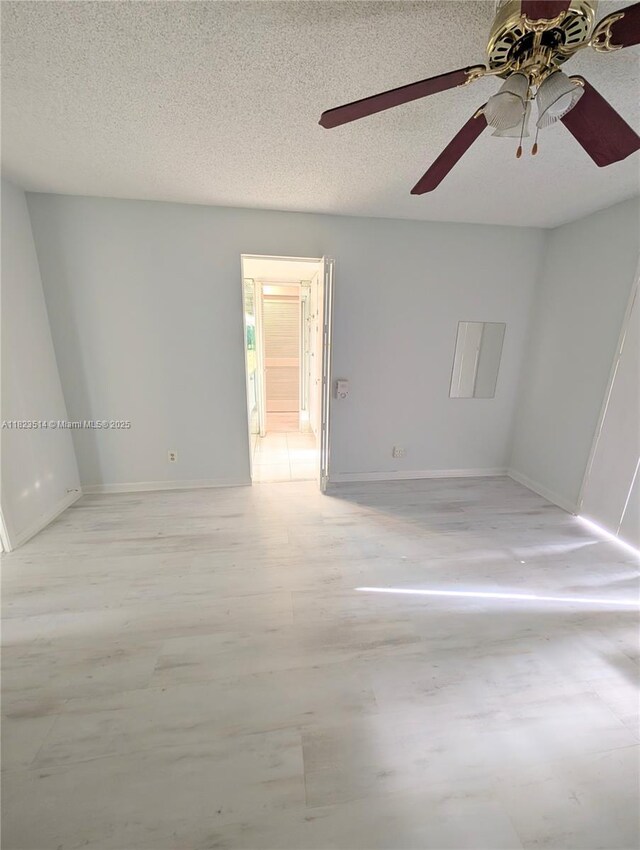 14901 SW 4th St Unit 9A, Pembroke Pines, FL 33027 - empty room with a ceiling fan, a textured ceiling, and light wood-style flooring