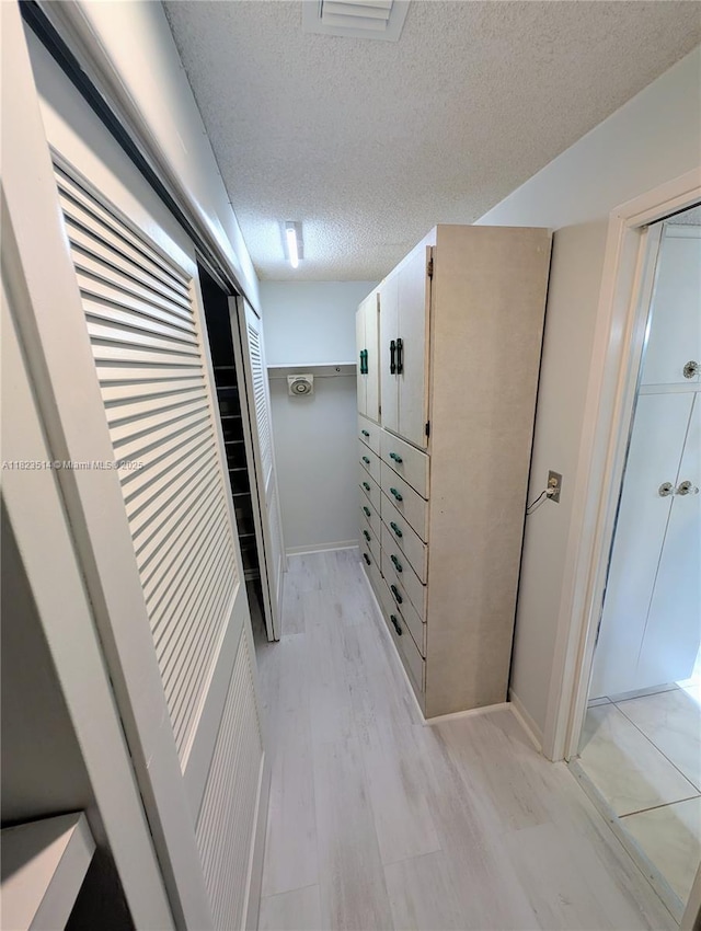 14901 SW 4th St Unit 9A, Pembroke Pines, FL 33027 - corridor featuring a textured ceiling and light wood-style flooring
