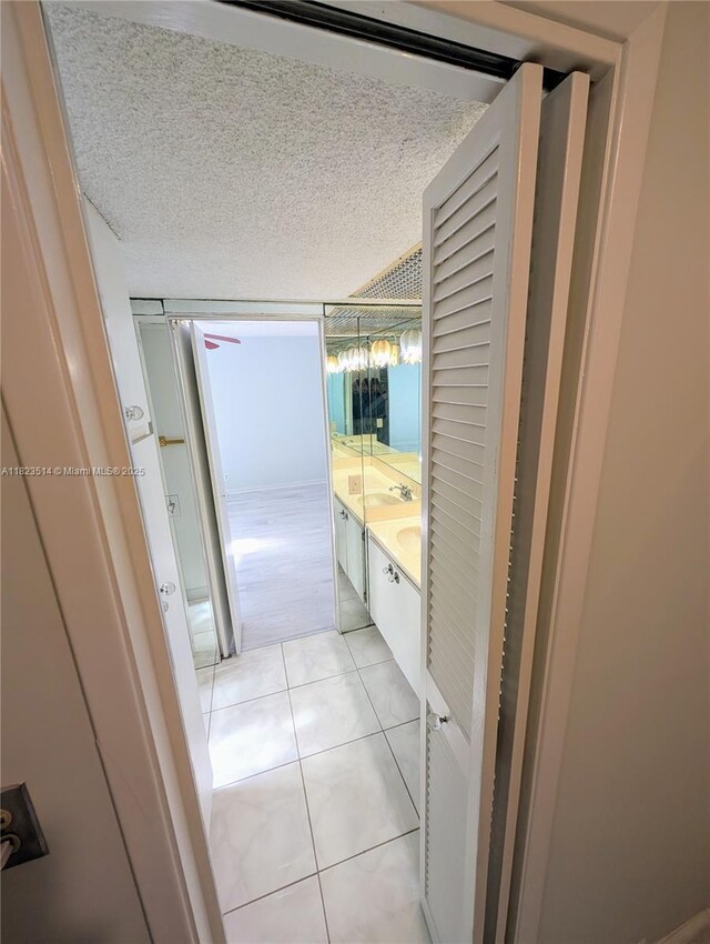 14901 SW 4th St Unit 9A, Pembroke Pines, FL 33027 - bathroom with tile patterned floors, double vanity, and a textured ceiling