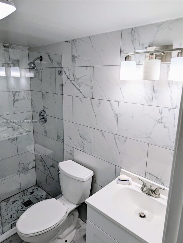 14901 SW 4th St Unit 9A, Pembroke Pines, FL 33027 - bathroom with a tile shower, vanity, and tile walls