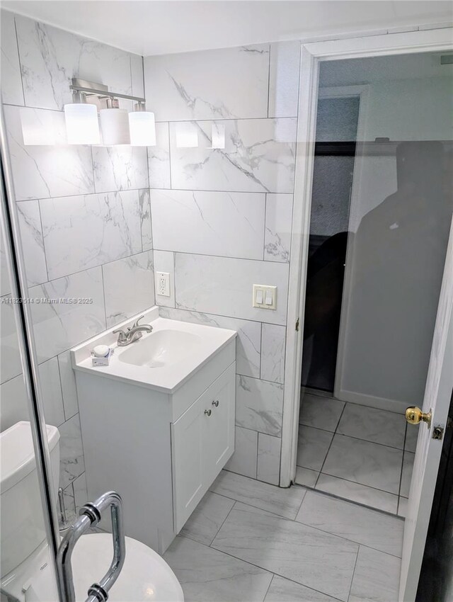 14901 SW 4th St Unit 9A, Pembroke Pines, FL 33027 - bathroom with tile walls, marble finish floors, and vanity