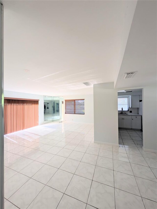 14901 SW 4th St Unit 9A, Pembroke Pines, FL 33027 - spare room with light tile patterned floors and a sink