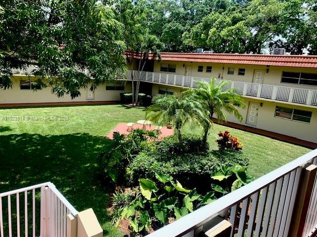 14901 SW 4th St Unit 9A, Pembroke Pines, FL 33027 - view of green lawn with a balcony