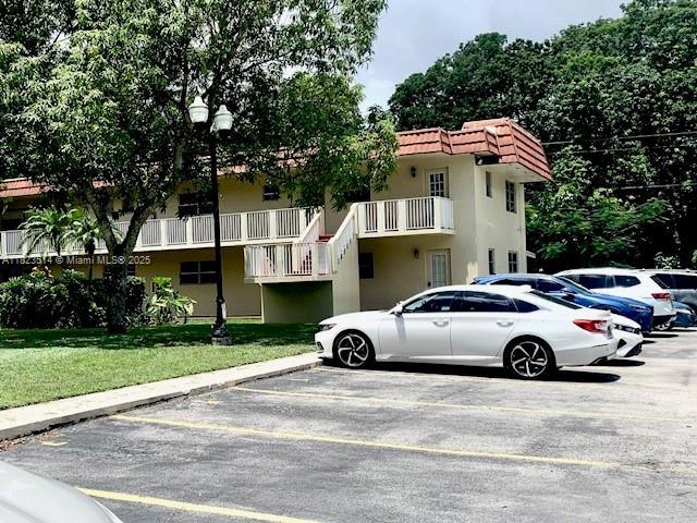 14901 SW 4th St Unit 9A, Pembroke Pines, FL 33027 - view of property featuring uncovered parking