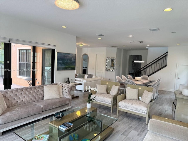 11455 Solstice Cir, Parkland, FL 33076 - living area featuring wood finished floors, stairway, recessed lighting, and arched walkways