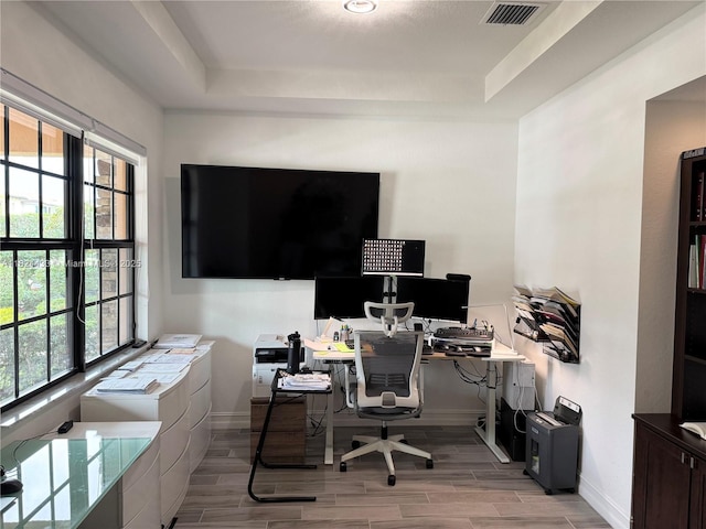 11455 Solstice Cir, Parkland, FL 33076 - home office with a tray ceiling, healthy amount of natural light, and wood finish floors