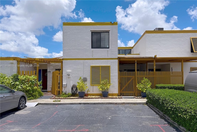 1209 SW 131st Place Cir W, Miami, FL 33184 - view of front facade featuring uncovered parking, stucco siding, and a gate
