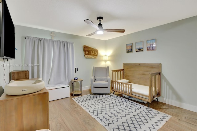 1209 SW 131st Place Cir W, Miami, FL 33184 - bedroom featuring wood finished floors, a crib, a baseboard heating unit, and a ceiling fan