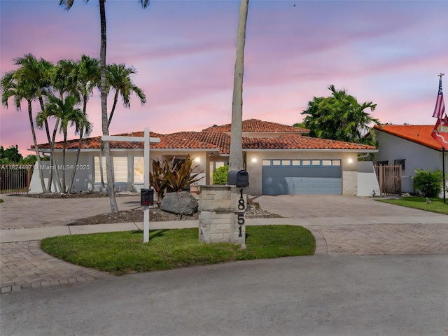 1851 SW 126th Ct, Miami, FL 33175 - view of front facade featuring decorative driveway, a tiled roof, an attached garage, and stucco siding