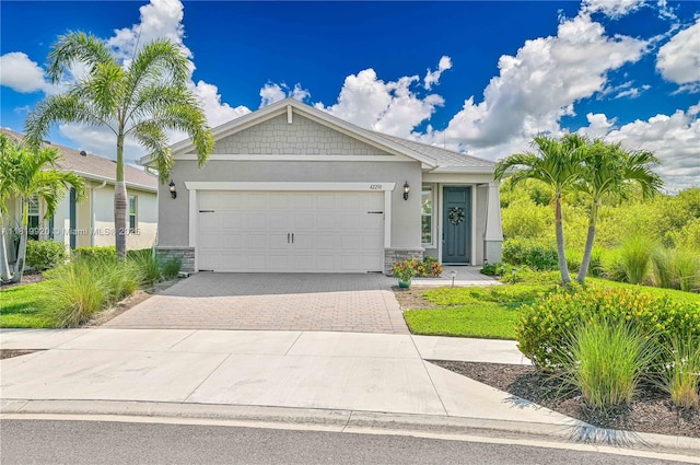 42250 Ramble Rd, Punta Gorda, FL 33982 - view of front of property with stucco siding, a garage, driveway, and stone siding