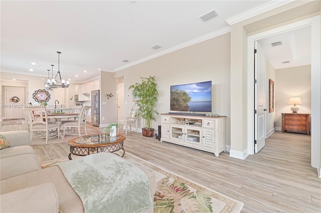 42250 Ramble Rd, Punta Gorda, FL 33982 - living room featuring light wood finished floors, crown molding, recessed lighting, and a chandelier
