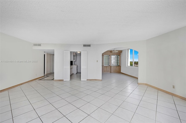 5401 Collins Ave Unit 419, Miami Beach, FL 33140 - empty room featuring arched walkways, a textured ceiling, and light tile patterned flooring