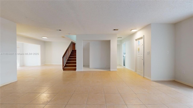 14263 SW 97th Ter, Miami, FL 33186 - empty room with stairs, light tile patterned floors, and a textured ceiling