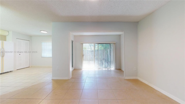 14263 SW 97th Ter, Miami, FL 33186 - unfurnished room with plenty of natural light, light tile patterned floors, and a textured ceiling