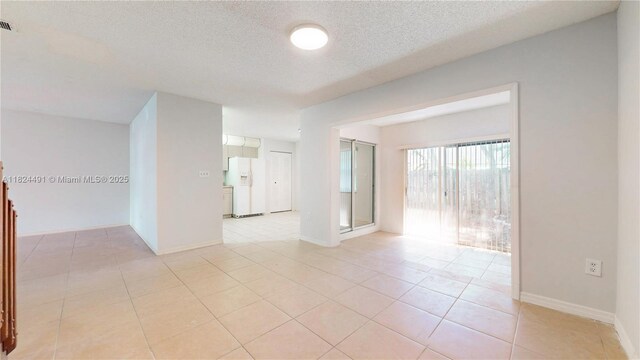 14263 SW 97th Ter, Miami, FL 33186 - empty room featuring light tile patterned flooring and a textured ceiling