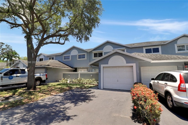 14263 SW 97th Ter, Miami, FL 33186 - view of property with stucco siding, asphalt driveway, a garage, and roof with shingles