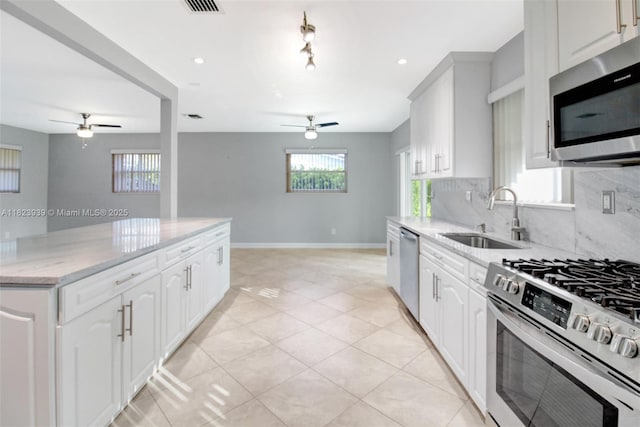 6255 SW 62nd Ct, South Miami, FL 33143 - kitchen featuring a ceiling fan, stainless steel appliances, backsplash, light stone counters, and recessed lighting