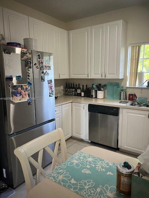 4812 Washington St Unit 8, Hollywood, FL 33021 - kitchen featuring appliances with stainless steel finishes, white cabinetry, light countertops, and light tile patterned flooring