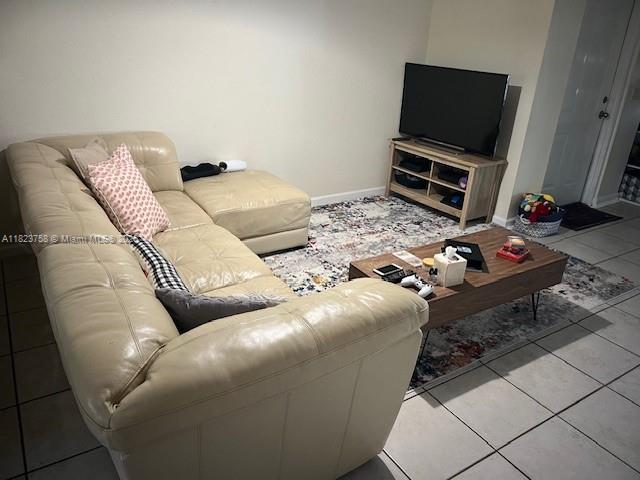 4812 Washington St Unit 8, Hollywood, FL 33021 - living room with tile patterned floors and baseboards